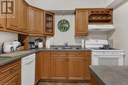 Kitchen with sink, extractor fan, and white appliances - 