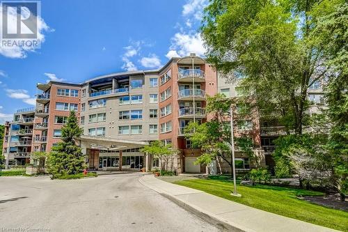 View of building exterior - 77 Governors Road Unit# 501, Dundas, ON - Outdoor With Balcony With Facade