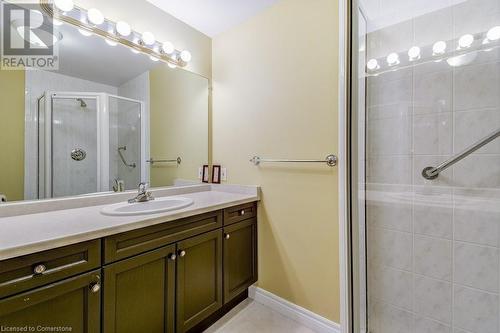 Bathroom with tile patterned floors, vanity, and an enclosed shower - 77 Governors Road Unit# 501, Dundas, ON - Indoor Photo Showing Bathroom