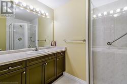 Bathroom with tile patterned floors, vanity, and an enclosed shower - 