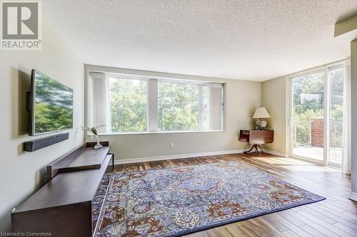 Sitting room featuring a textured ceiling and hardwood / wood-style flooring - 77 Governors Road Unit# 501, Dundas, ON - Indoor