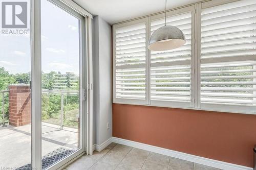 Doorway to outside with light tile patterned floors and a wealth of natural light - 77 Governors Road Unit# 501, Dundas, ON - Indoor Photo Showing Other Room