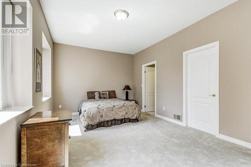 View of carpeted bedroom - 77 Governors Road Unit# 501, Dundas, ON - Indoor Photo Showing Bedroom