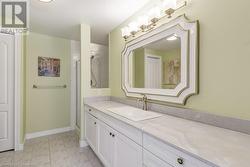 Bathroom with vanity and a shower with shower door - 