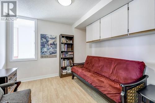 Living area featuring light wood-type flooring and a textured ceiling - 77 Governors Road Unit# 501, Dundas, ON - Indoor