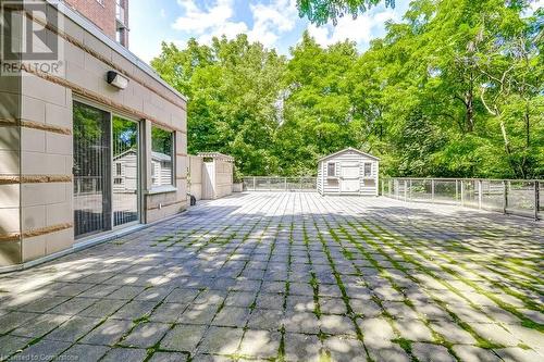 View of yard with a patio and a storage shed - 77 Governors Road Unit# 501, Dundas, ON - Outdoor