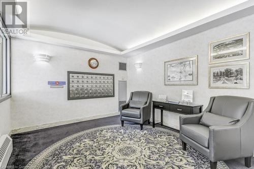 Living area featuring carpet flooring, vaulted ceiling, and a mail area - 77 Governors Road Unit# 501, Dundas, ON - Indoor