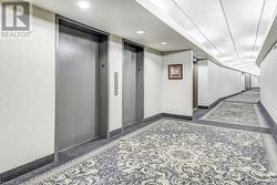 Hallway featuring elevator - 