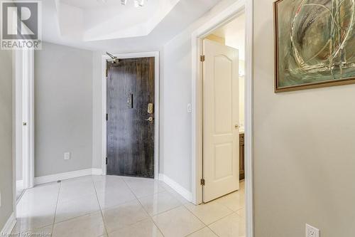 Corridor with light tile patterned floors - 77 Governors Road Unit# 501, Dundas, ON - Indoor Photo Showing Other Room