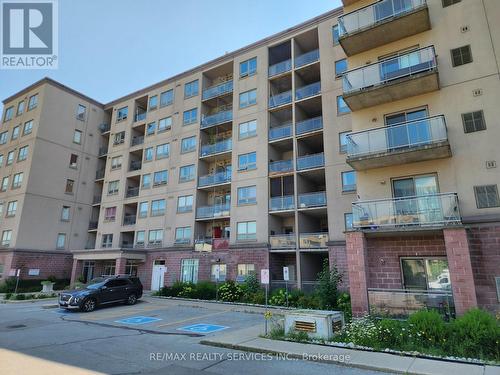 212 - 7405 Goreway Drive W, Mississauga, ON - Outdoor With Balcony With Facade