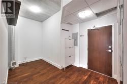 Foyer entrance with dark hardwood / wood-style flooring and electric panel - 