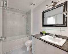 Full bathroom featuring tile patterned floors, vanity, toilet, and tiled shower / bath - 