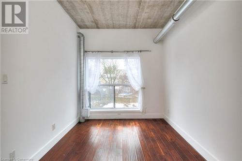 Spare room with dark hardwood / wood-style floors - 15 Devitt Avenue S Unit# 103, Waterloo, ON - Indoor Photo Showing Other Room