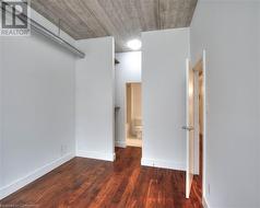 Empty room featuring dark wood-type flooring - 