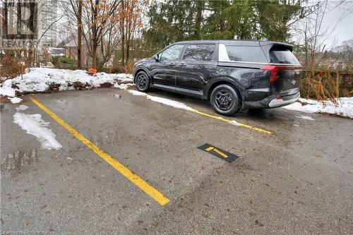 View of snow covered parking area - 15 Devitt Avenue S Unit# 103, Waterloo, ON - Outdoor