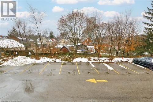 View of snow covered parking area - 15 Devitt Avenue S Unit# 103, Waterloo, ON - Outdoor With View