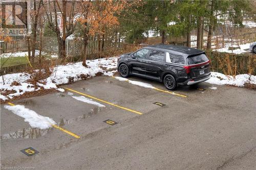 View of snow covered parking area - 15 Devitt Avenue S Unit# 103, Waterloo, ON - Outdoor