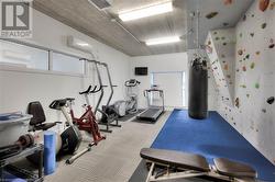 Exercise room with an AC wall unit and light colored carpet - 