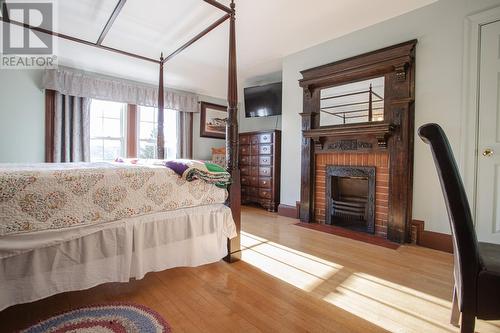 170 Water Street, Carbonear, NL - Indoor Photo Showing Bedroom With Fireplace