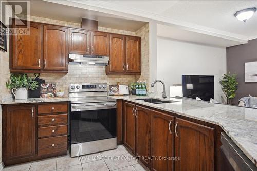 410 - 112 Simcoe Road, Bradford West Gwillimbury, ON - Indoor Photo Showing Kitchen With Double Sink