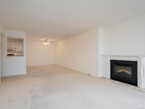 404-1560 Hillside Ave, Victoria, BC - Indoor Photo Showing Living Room With Fireplace