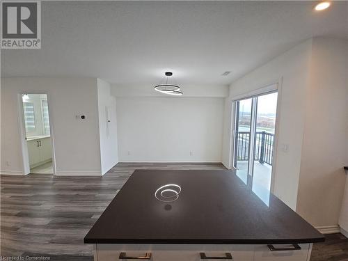 Unfurnished dining area featuring a textured ceiling and dark hardwood / wood-style flooring - 235 Chapel Hill Dr Drive Unit# 16, Kitchener, ON - Indoor Photo Showing Other Room