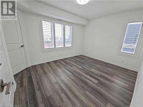 Empty room with dark hardwood / wood-style floors - 235 Chapel Hill Dr Drive Unit# 16, Kitchener, ON - Indoor Photo Showing Other Room