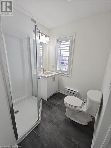 Bathroom with vanity, a baseboard radiator, toilet, and walk in shower - 235 Chapel Hill Dr Drive Unit# 16, Kitchener, ON - Indoor Photo Showing Bathroom