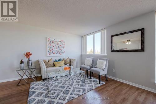 414 - 2460 Eglinton Avenue E, Toronto, ON - Indoor Photo Showing Living Room