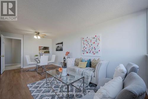 414 - 2460 Eglinton Avenue E, Toronto, ON - Indoor Photo Showing Living Room