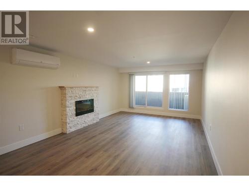 Bright Living Toom - 217 Elm Avenue Unit# 209, Penticton, BC - Indoor Photo Showing Living Room With Fireplace