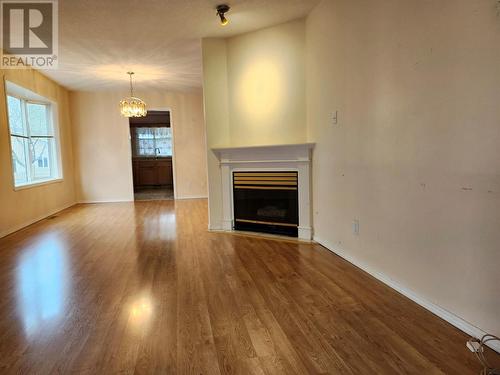 Living to dining to kitchen - 1038 11 Avenue Unit# 19, Vernon, BC - Indoor Photo Showing Living Room With Fireplace