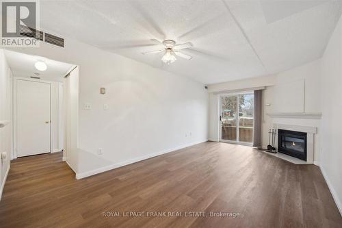 114 - 95 Wellington Street, Clarington (Bowmanville), ON - Indoor Photo Showing Living Room With Fireplace