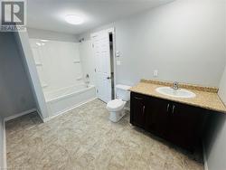 Full bathroom featuring vanity, washtub / shower combination, and toilet - 