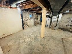 Basement featuring gas water heater and heating unit - 