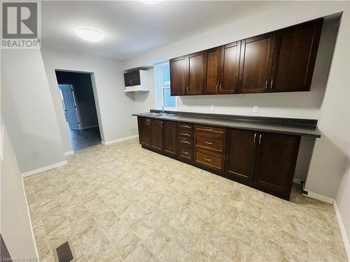 Kitchen with dark brown cabinets and sink - 472 First Ave W, North Bay, ON - Indoor Photo Showing Other Room