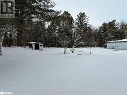 Snowy yard featuring an outbuilding - 