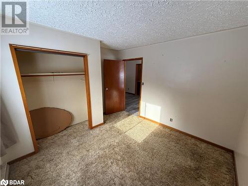 Unfurnished bedroom featuring a textured ceiling, carpet floors, and a closet - 32299 Highway 17 E, Deep River, ON - Indoor Photo Showing Other Room