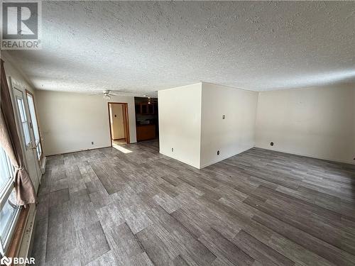 Spare room featuring ceiling fan, a textured ceiling, and hardwood / wood-style flooring - 32299 Highway 17 E, Deep River, ON - Indoor Photo Showing Other Room