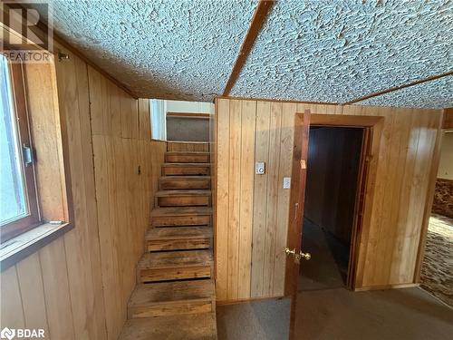 Stairway with wood walls and a textured ceiling - 32299 Highway 17 E, Deep River, ON - Indoor Photo Showing Other Room