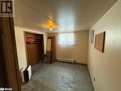 Unfurnished bedroom featuring a closet, ornamental molding, and a baseboard radiator - 