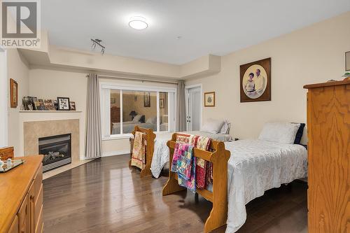 1961 Durnin Road Unit# 105, Kelowna, BC - Indoor Photo Showing Bedroom With Fireplace