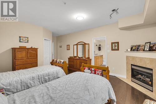 1961 Durnin Road Unit# 105, Kelowna, BC - Indoor Photo Showing Bedroom With Fireplace