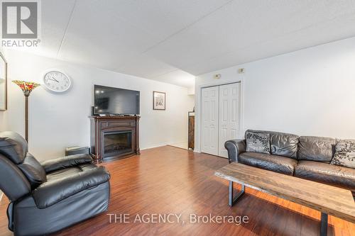 102 - 1810 Walkers Line, Burlington (Palmer), ON - Indoor Photo Showing Living Room With Fireplace