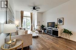 Living room with ceiling fan and wood-type flooring - 