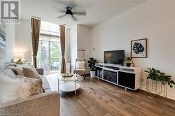 Living room with hardwood / wood-style floors and ceiling fan - 