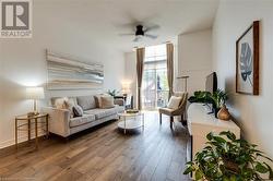 Living area featuring hardwood / wood-style flooring and ceiling fan - 