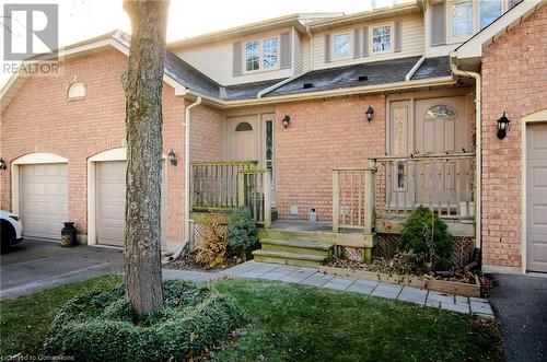 Doorway to property featuring covered porch and a garage - 79 Braeheid Avenue Avenue Unit# 6, Hamilton, ON - Outdoor With Exterior