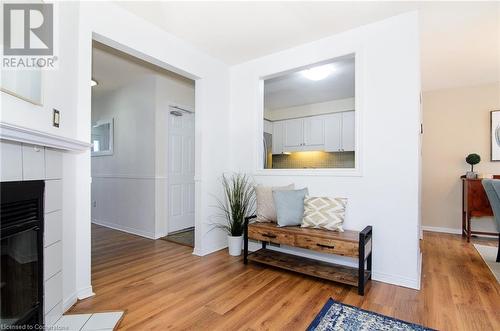 Hallway featuring light hardwood / wood-style floors - 79 Braeheid Avenue Avenue Unit# 6, Hamilton, ON - Indoor With Fireplace