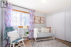 Bedroom featuring a closet and a nursery area - 